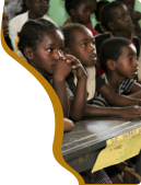 Children in a classroom looking at their teacher